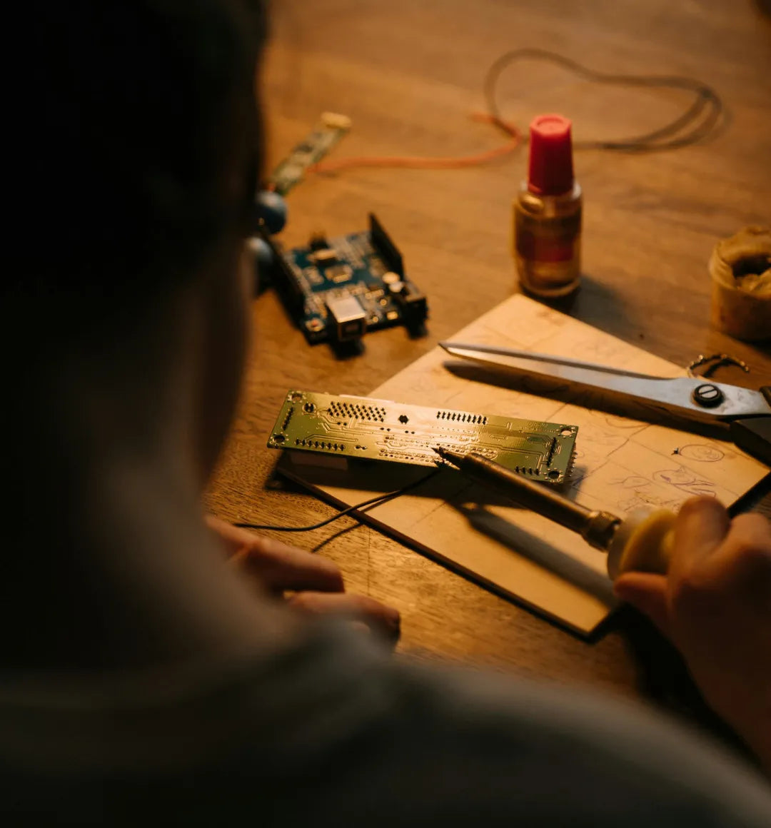 Person Soldering Board