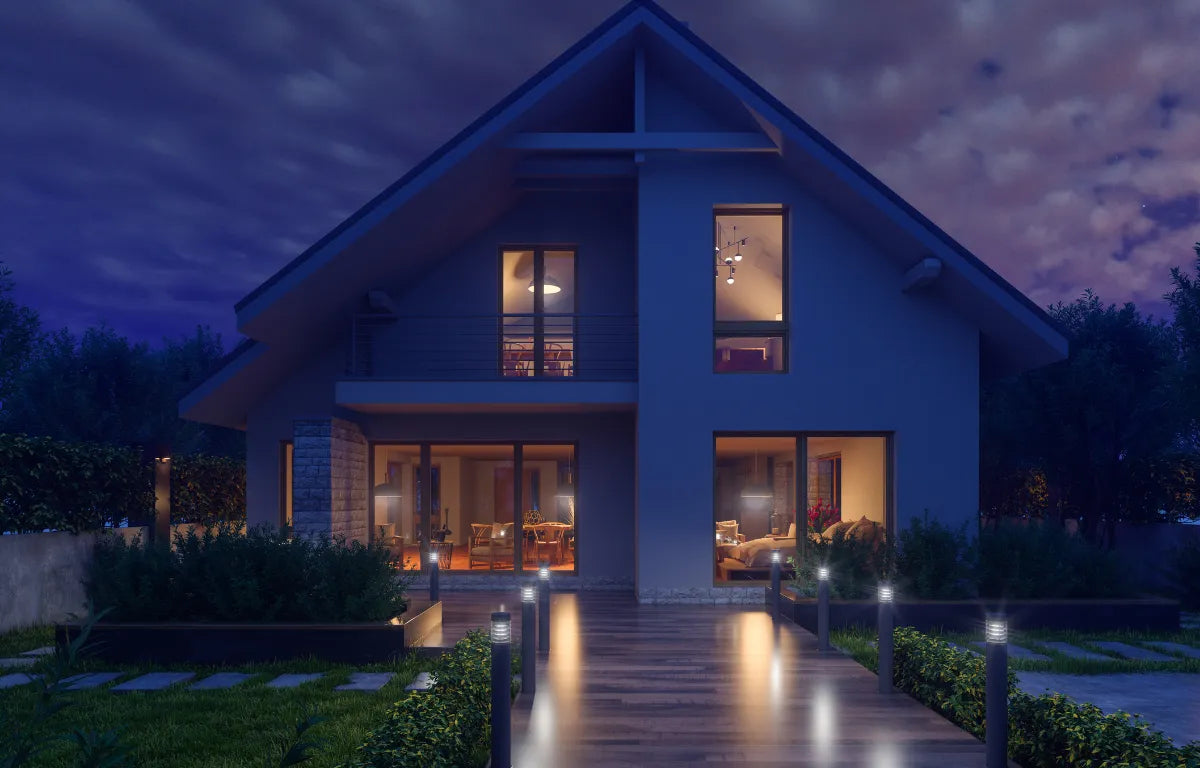 Beautiful Modern Home with Outdoor and Indoor Lights On At Sunset